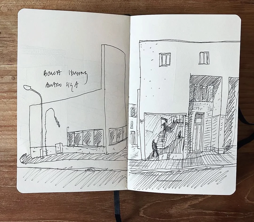 Open sketchbook with an observational ink sketch of Siza's Bouça housing showing controlled line work